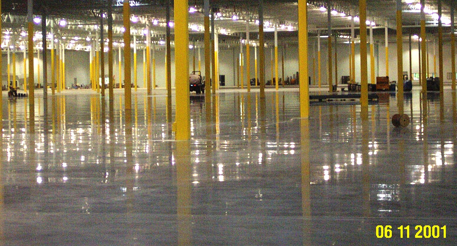 Yellow columns rise from a polished concrete floor in a Volkswagen parts warehouse in WI.